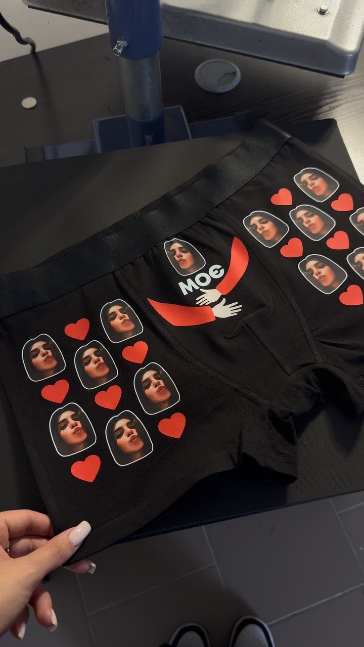 13 Funny Gag Gift Ideas for Birthdays and Office Parties 8 Black boxer briefs printed with repeated faces and red hearts as a gag gift.