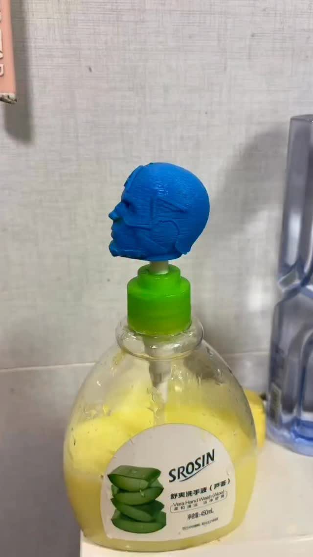 13 Funny Gag Gift Ideas for Birthdays and Office Parties 11 Soap dispenser bottle with a blue 3D-printed man's head as a topper.