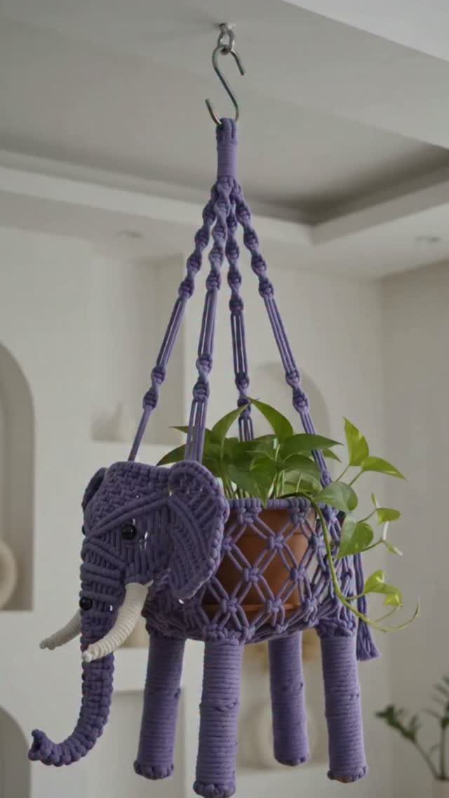 13 Funny Gag Gift Ideas for Birthdays and Office Parties 3 Purple macrame elephant plant hanger holding a small potted green plant from ceiling