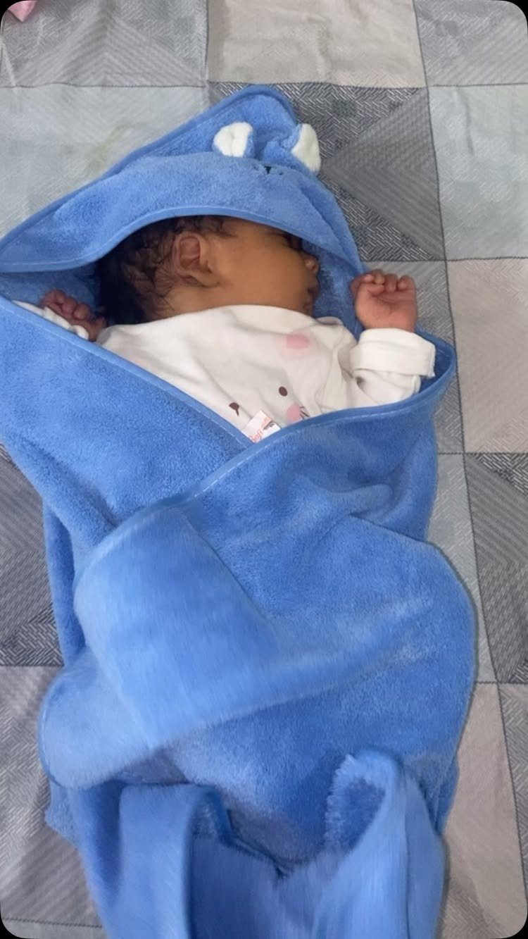 5 Gender Reveal Gifts for Parents-to-Be and Baby 5 Newborn baby wrapped in a light blue hooded towel with small white ears.