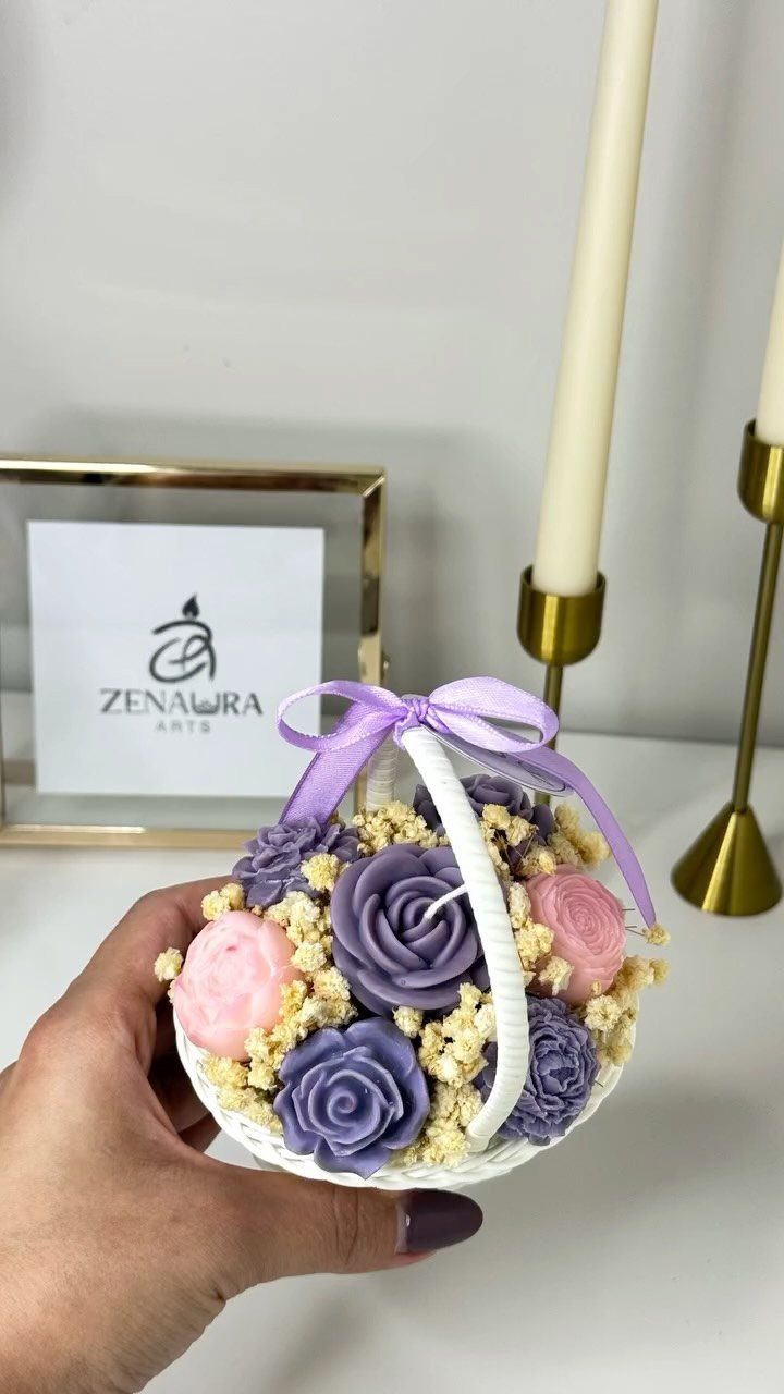 15 Gift Basket Alternative Ideas for Any Occasion 7 Small white basket filled with purple and pink rose-shaped candles and dried flowers.
