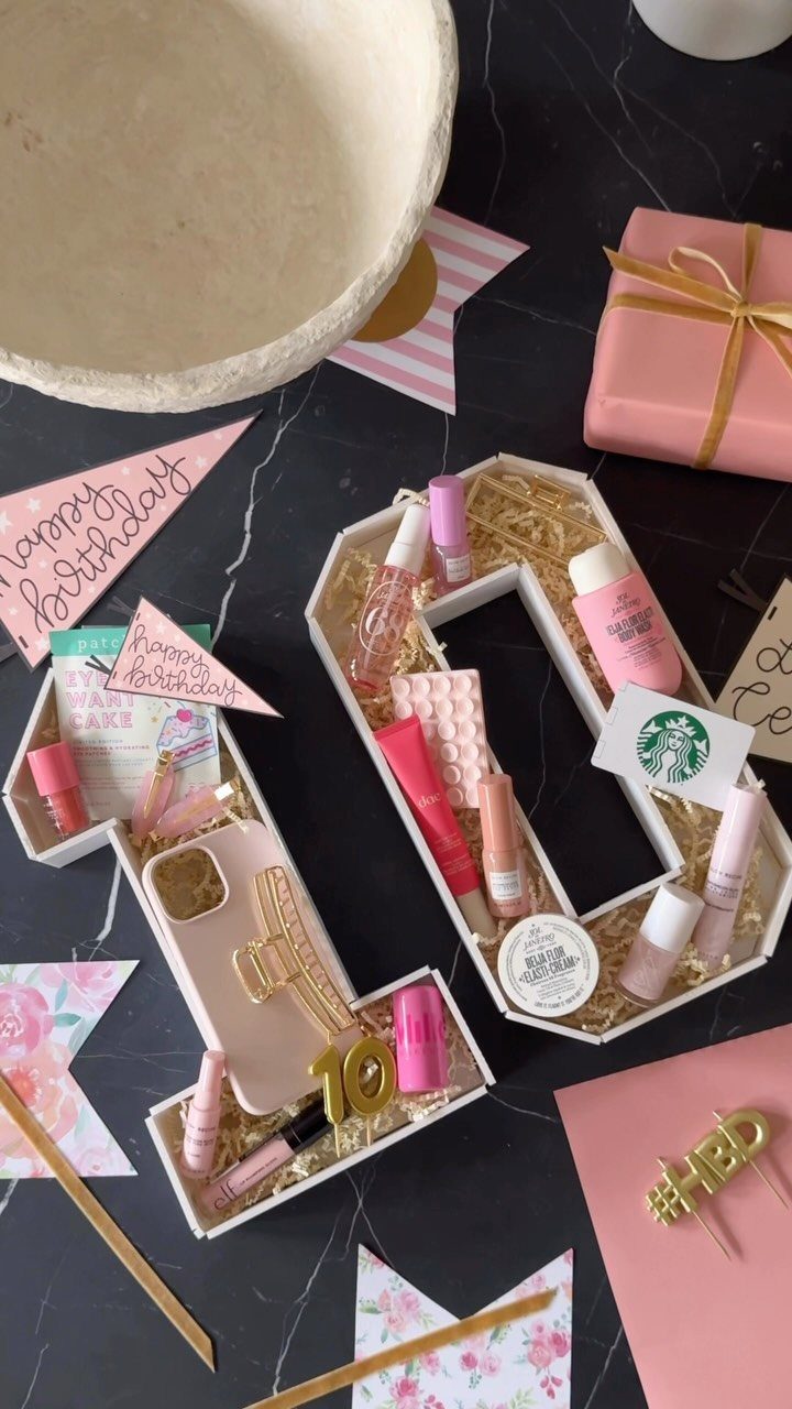 15 Gift Basket Alternative Ideas for Any Occasion 11 Number-shaped gift boxes filled with pink cosmetics and a gift card on marble.