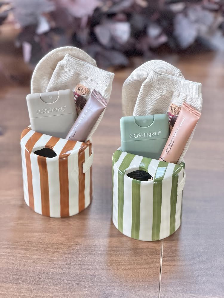 15 Gift Basket Alternative Ideas for Any Occasion 12 Striped ceramic pots filled with socks and skincare products as gift basket alternatives.