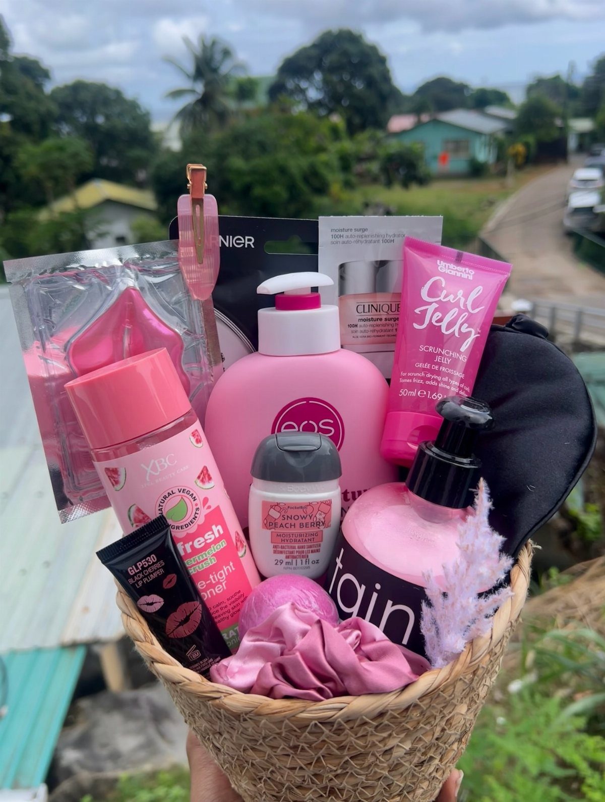 Gift Basket Design: 18 Ideas for Every Occasion 1 Woven basket filled with pink skincare products, beauty tools, and a silk scrunchie.