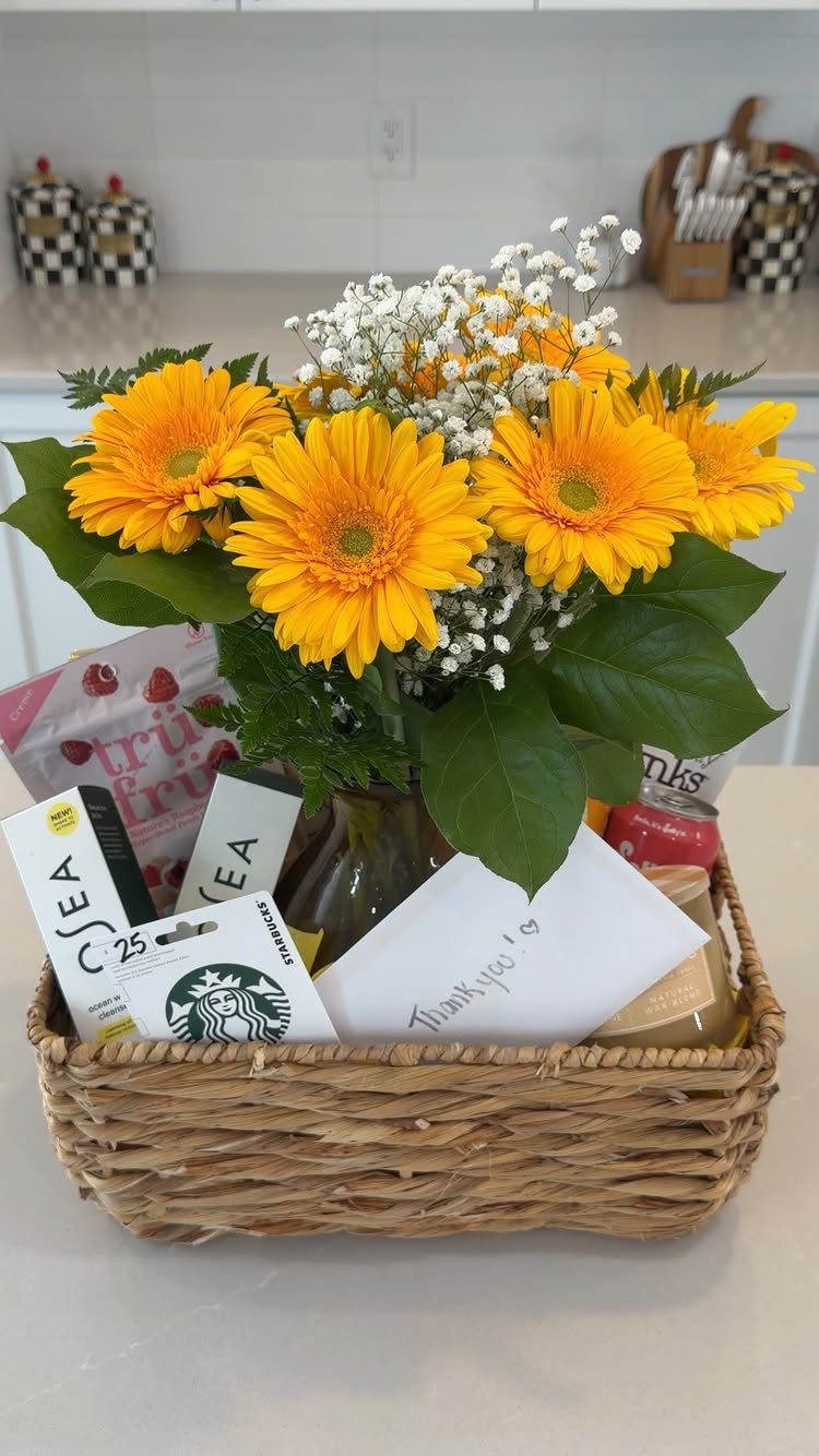 Woven gift basket with yellow daisies, a Starbucks gift card, and a thank-you note.