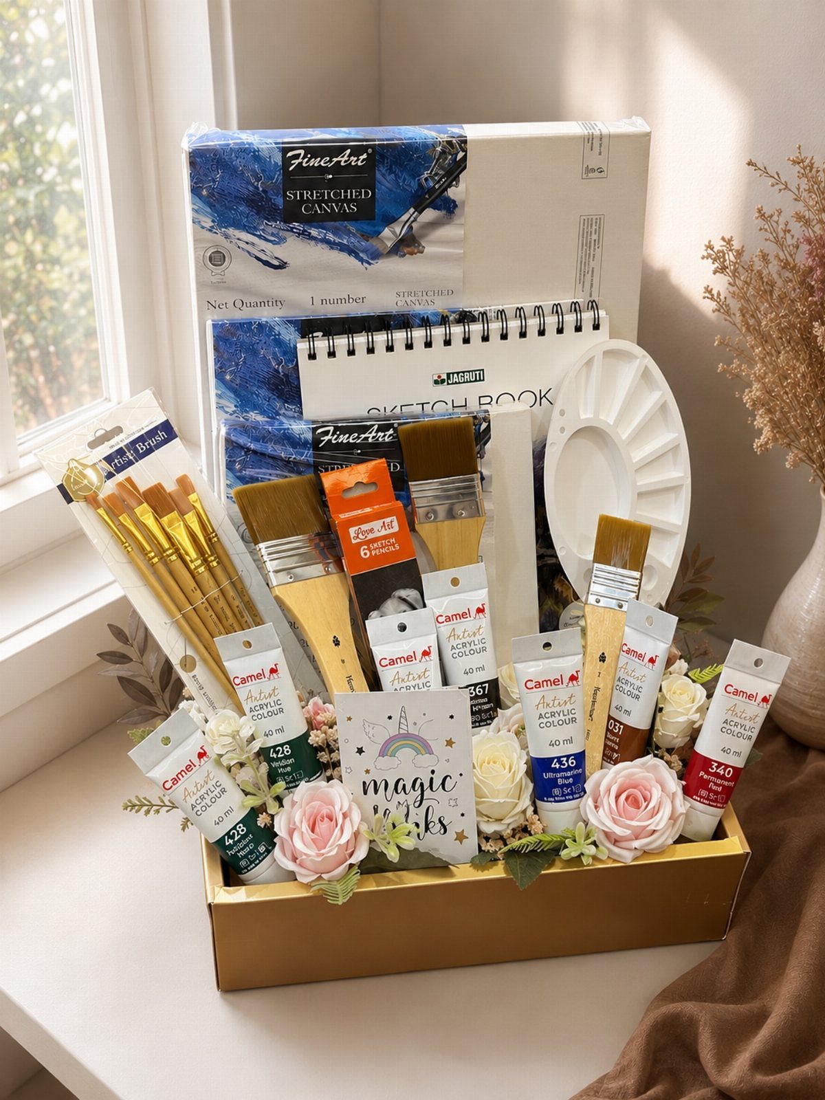 18 Gift Basket Prize Ideas for Raffles and Auctions 17 Art supplies gift basket with canvas, sketchbook, brushes, and paints decorated with roses.
