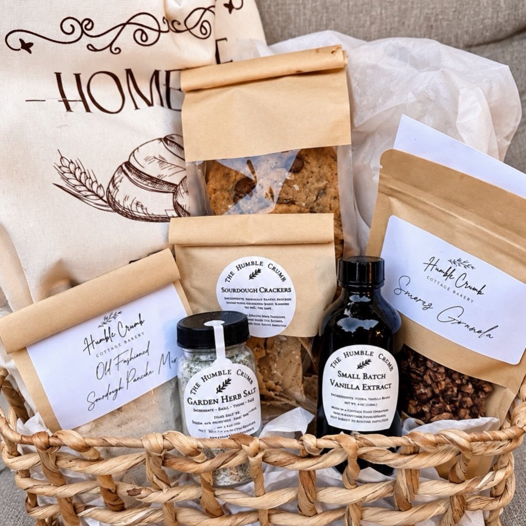 18 Gift Basket Prize Ideas for Raffles and Auctions 12 Woven wicker basket filled with artisan bakery goods, crackers, salt, and vanilla extract.