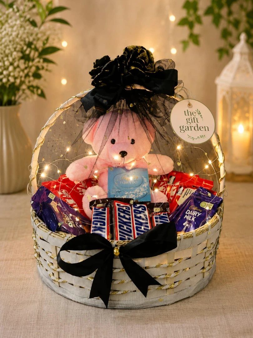18 Gift Basket Prize Ideas for Raffles and Auctions 5 Gift basket with a pink teddy bear and assorted chocolate bars wrapped in cellophane.