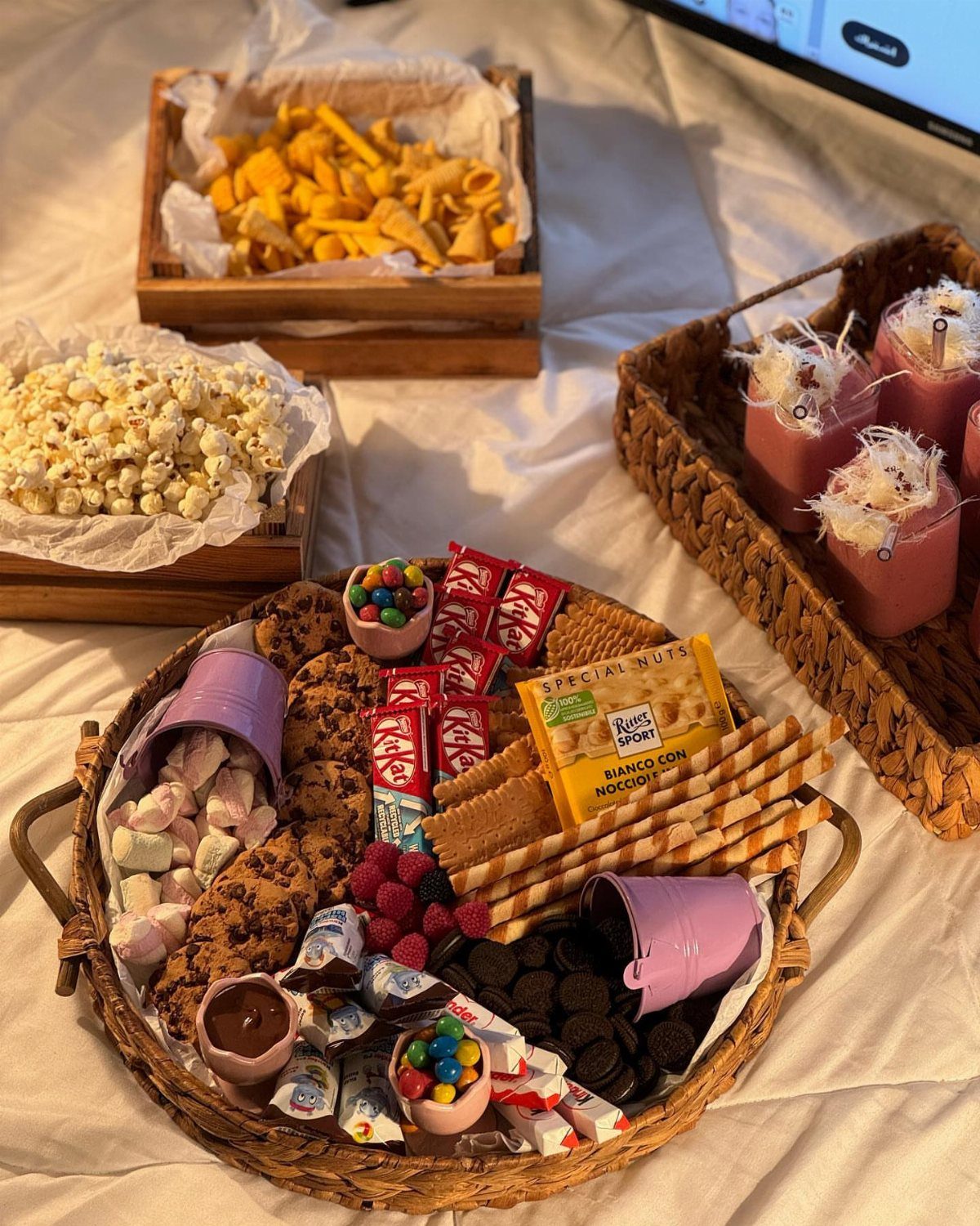 18 Gift Basket Prize Ideas for Raffles and Auctions 1 Wicker tray of sweets and snacks with popcorn and chips on a white cloth