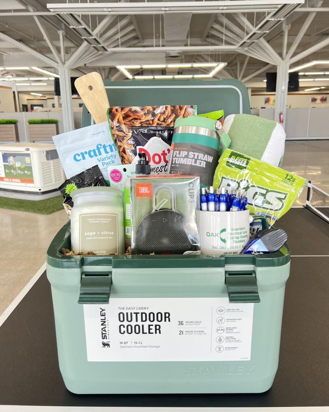 18 Gift Basket Prize Ideas for Raffles and Auctions 15 Light green outdoor cooler filled with snacks, a speaker, and a tumbler.