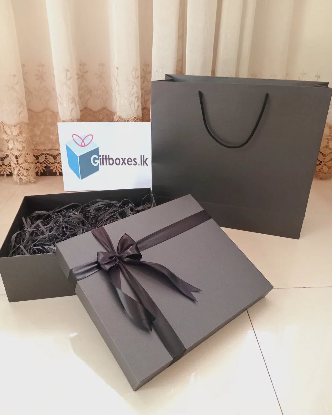 8 Gift Box Images: Red, Black, Pink, Blue and Clear 3 Matte black gift box with ribbon, open box, and matching shopping bag.