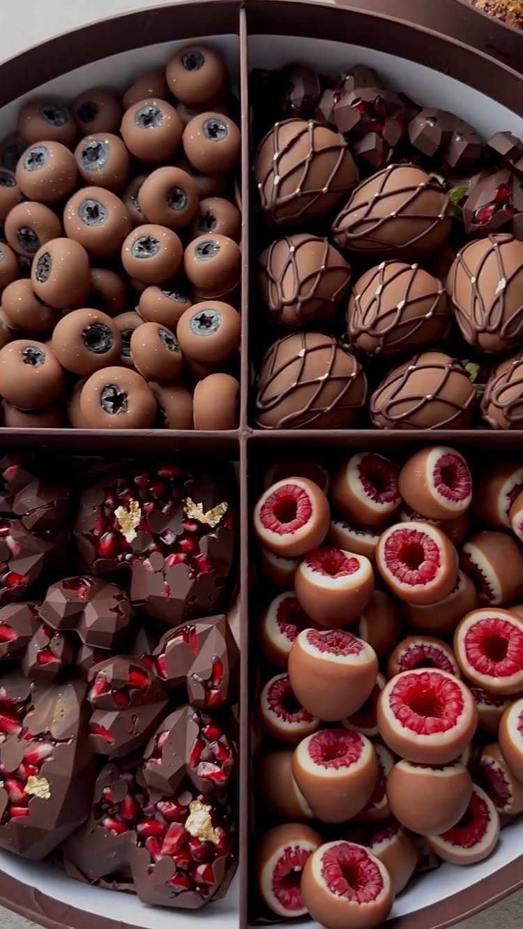 Assorted chocolate truffles and berries in a divided round gift box