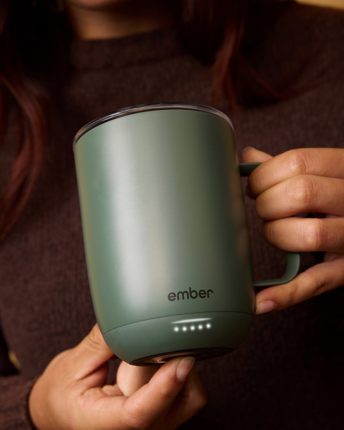 7 Gift Ideas on Amazon: Cozy, Techy and Easy to Wrap 7 Matte green Ember smart mug held by a person wearing a brown sweater.