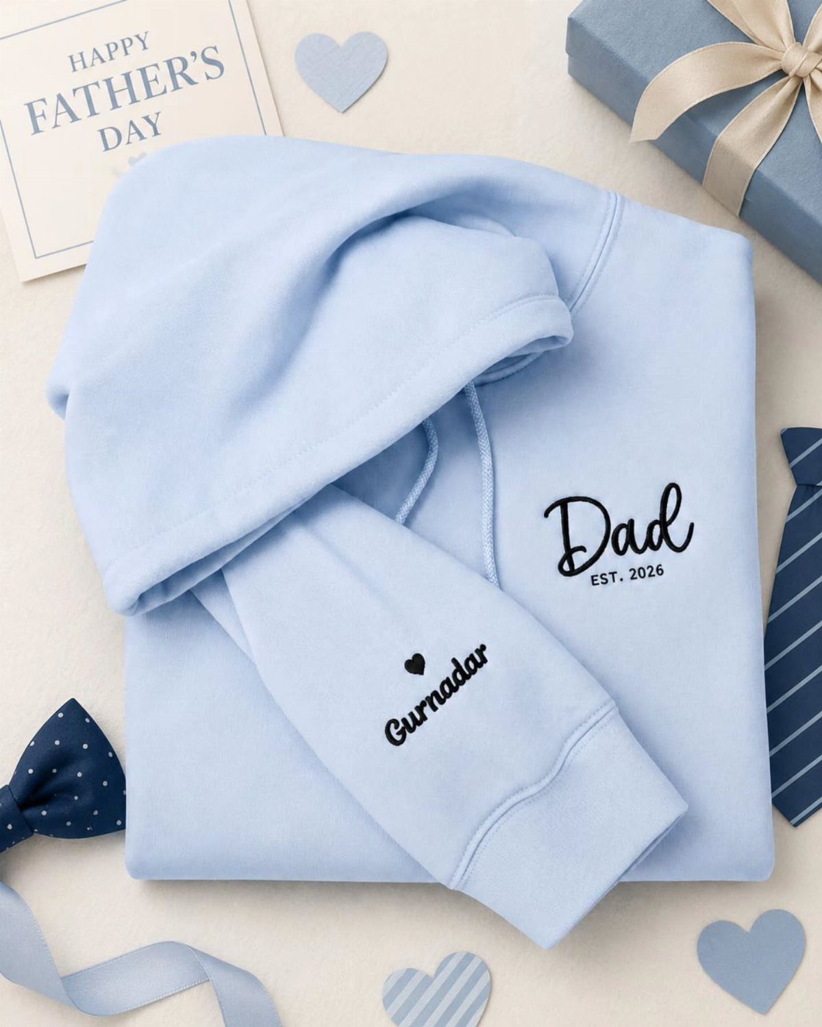 Light blue hoodie with Dad EST. 2026 embroidery and a Father's Day card.