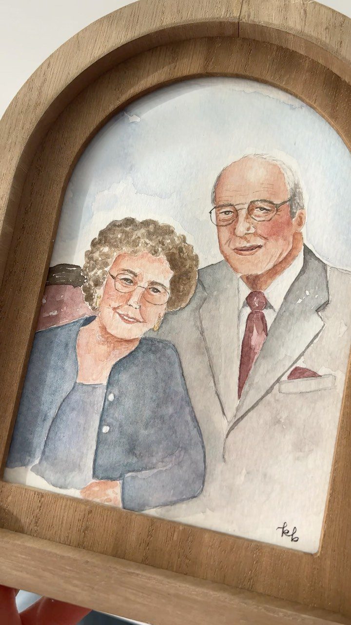 12 Good Gifts for Grandma She'll Actually Use and Treasure 5 Watercolor painting of an elderly couple inside an arched wooden frame.