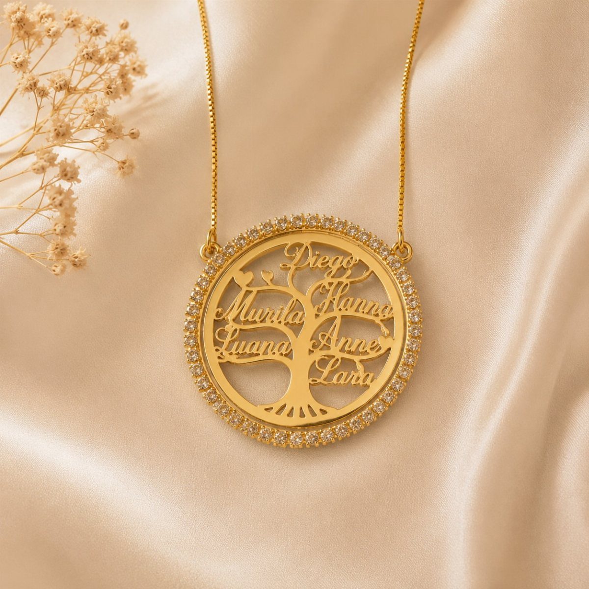 12 Good Gifts for Grandma She'll Actually Use and Treasure 4 Gold family tree necklace with engraved names on a cream satin background
