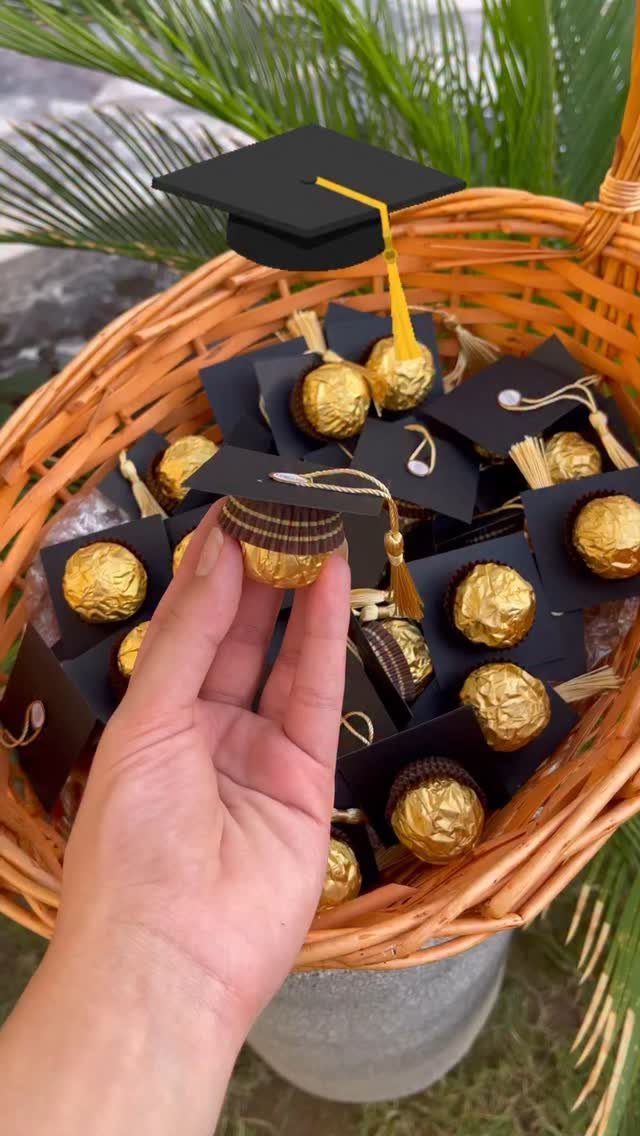 Hand holding a chocolate treat dressed as a graduation cap in a wicker basket