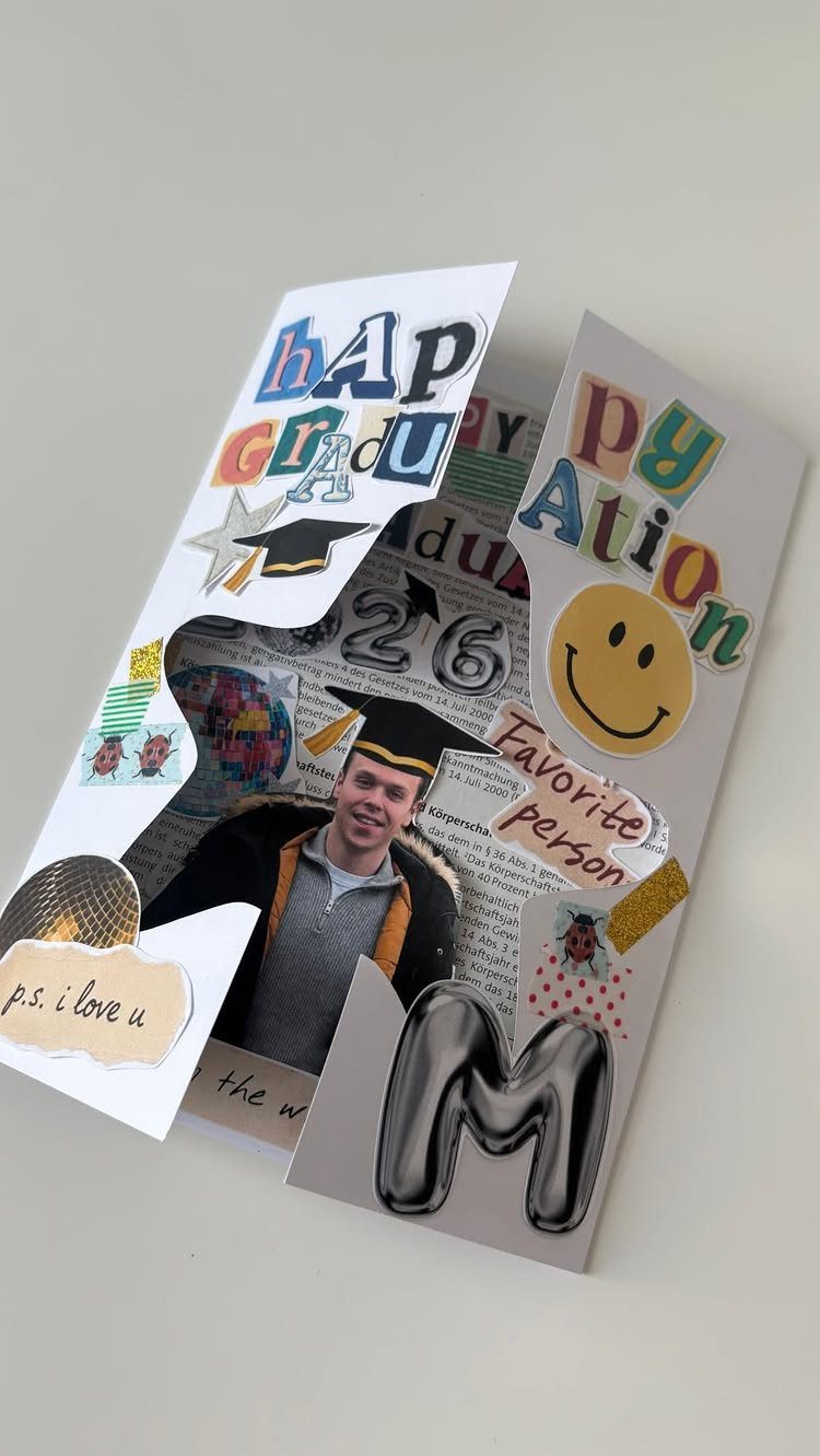 Handmade pop-up graduation card with a photo, colorful letters, and a smiley face.