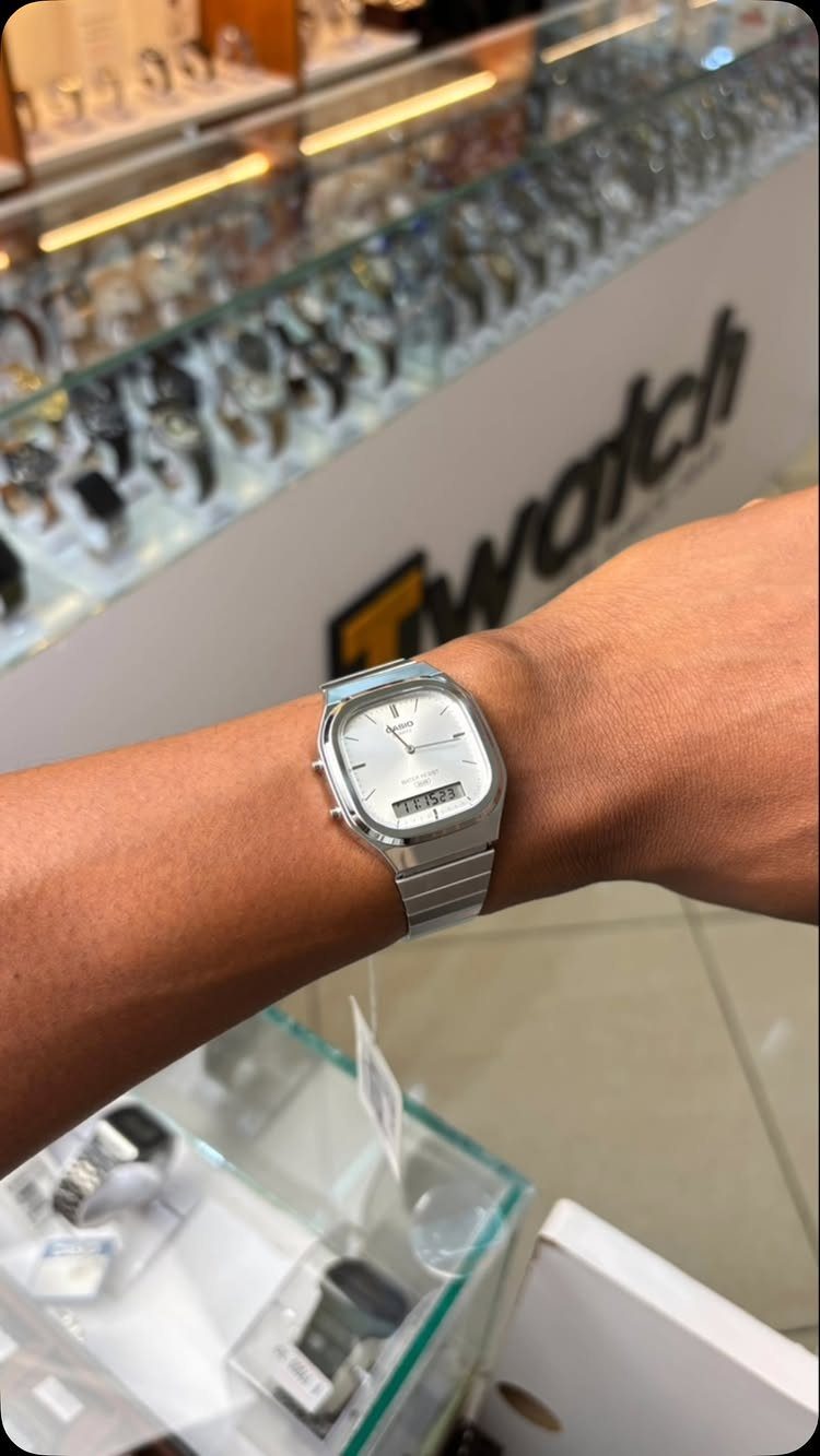 Silver Casio vintage watch on a person's wrist inside a watch store