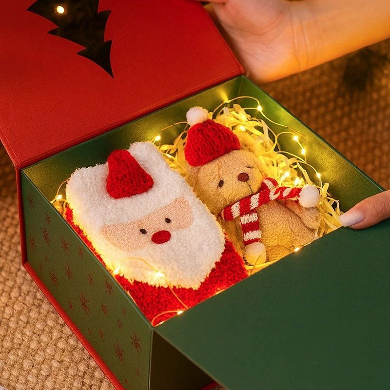 14 Holiday Christmas Gifts for Kids, Couples and Coworkers 10 Santa towel and teddy bear in a green gift box with fairy lights