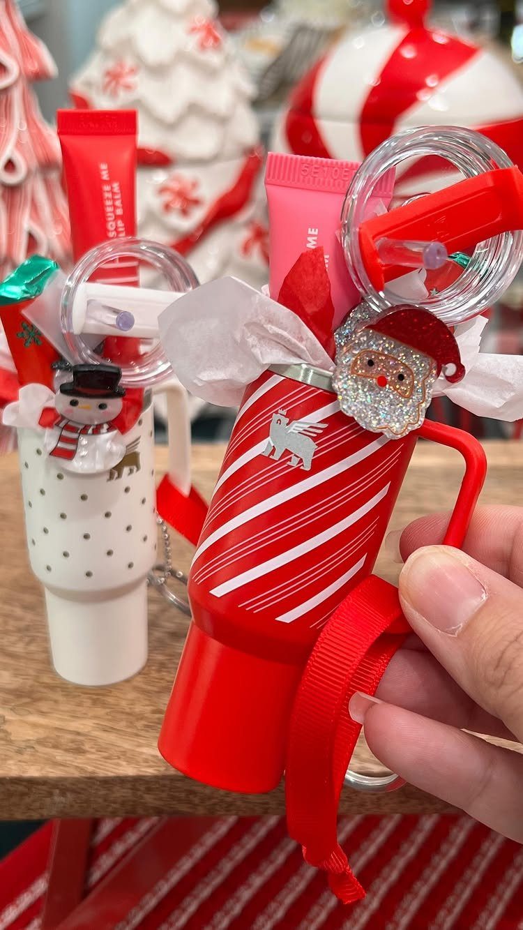 14 Holiday Christmas Gifts for Kids, Couples and Coworkers 2 Red striped holiday cup filled with small gifts and a Santa ornament.