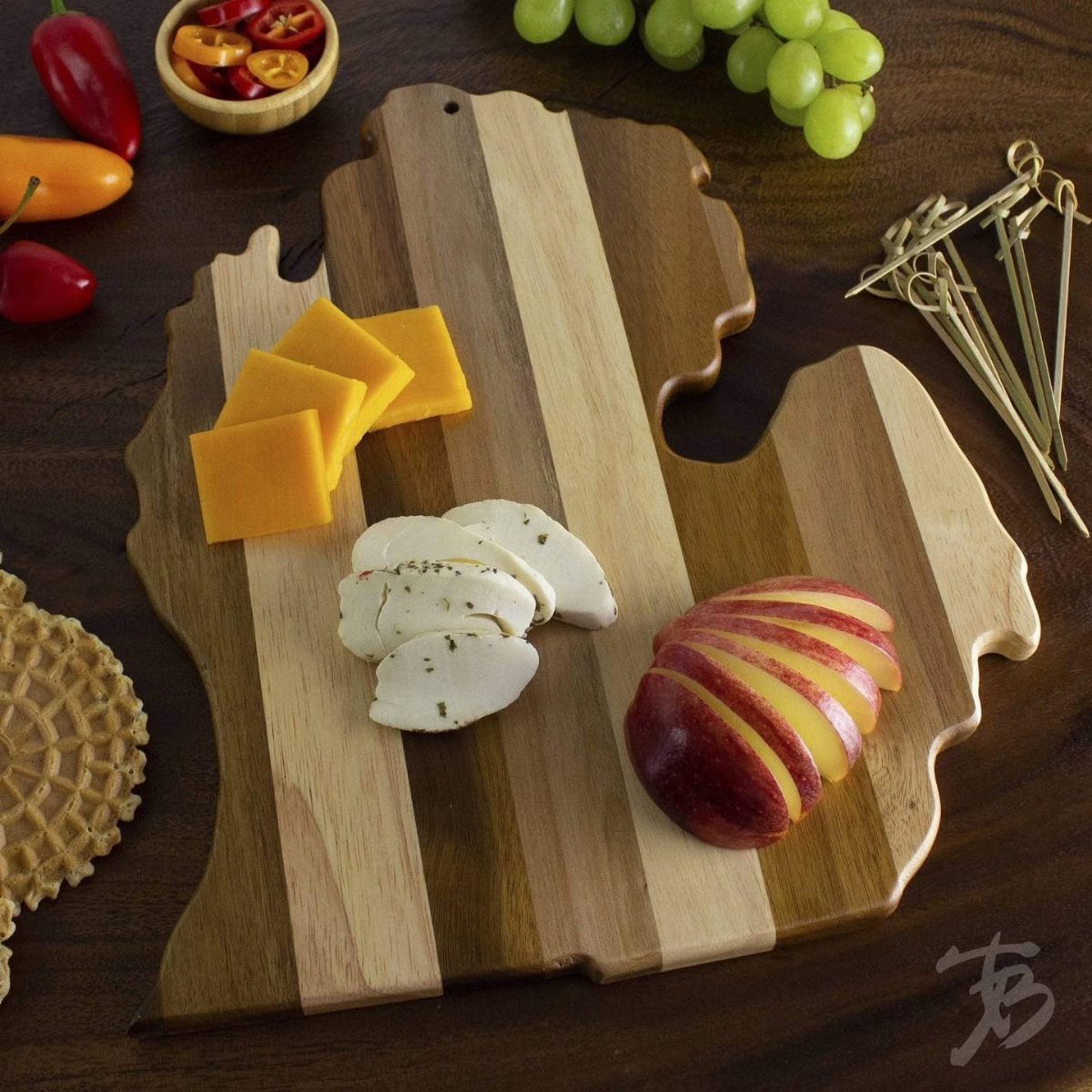 14 Holiday Christmas Gifts for Kids, Couples and Coworkers 12 USA shaped wooden cutting board with cheese, sliced apple, and grapes on table
