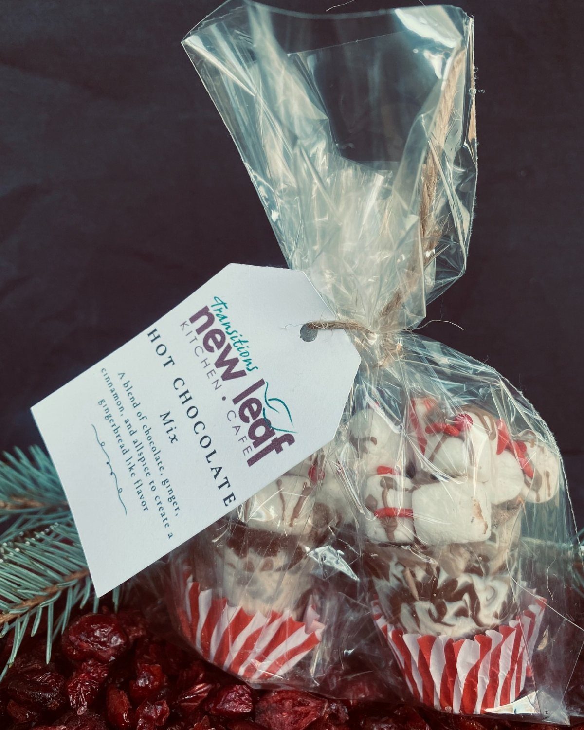 5 Holiday Coworker Gift Ideas for Every Budget 5 Hot chocolate mix gift bag with marshmallows and chocolate in striped liners.