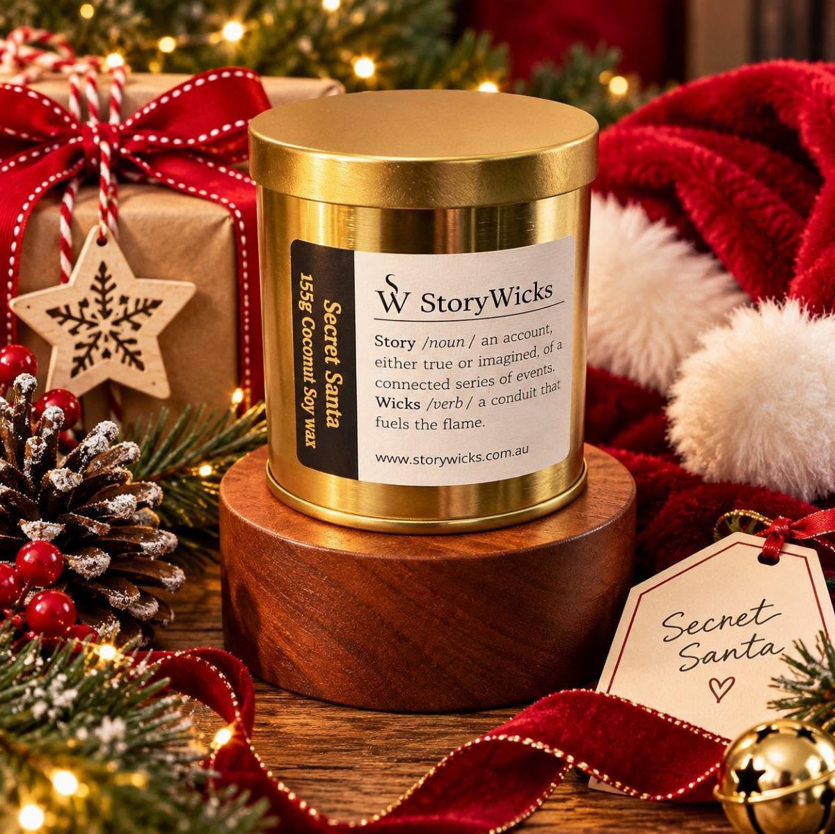 5 Holiday Coworker Gift Ideas for Every Budget 4 Gold candle tin on a wooden base surrounded by festive holiday decorations and gifts.