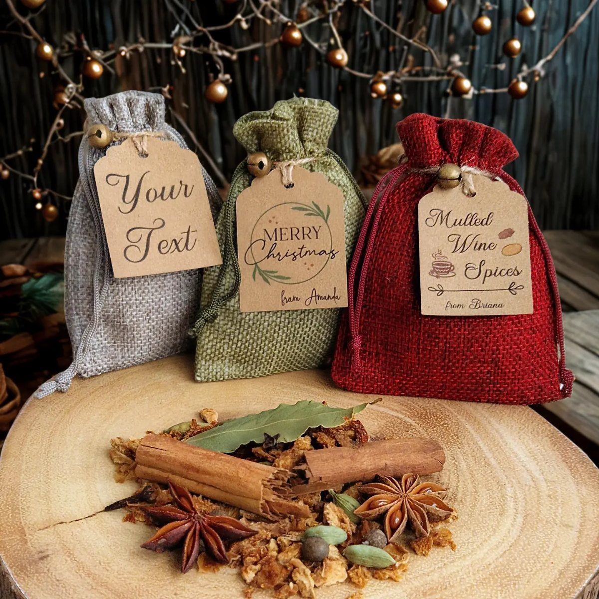 Three colorful fabric spice bags and loose cinnamon sticks on a wooden board.