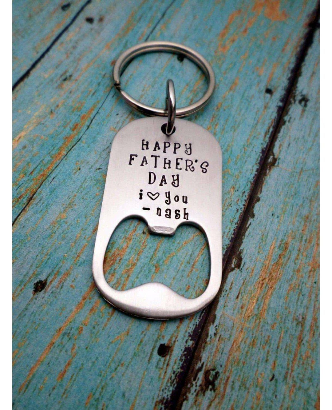 9 Homemade Father's Day Gifts Dad Will Actually Use 3 Silver metal keychain bottle opener with Father's Day message on blue wooden background