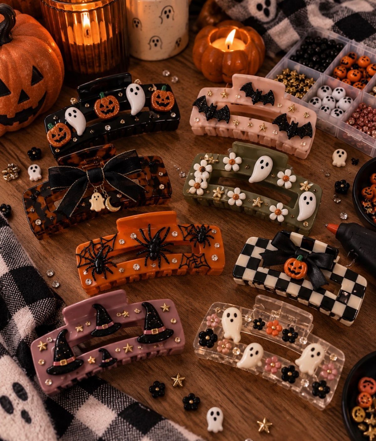 Halloween themed hair claws with ghosts and pumpkins on a wooden craft table