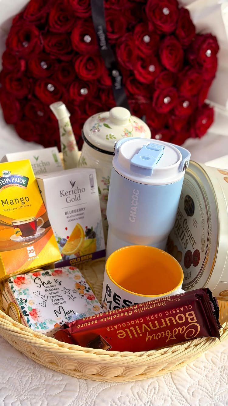 14 Household Gift Basket Ideas for Every Occasion 9 Wicker gift basket with tea boxes, mugs, chocolate, and red roses in background
