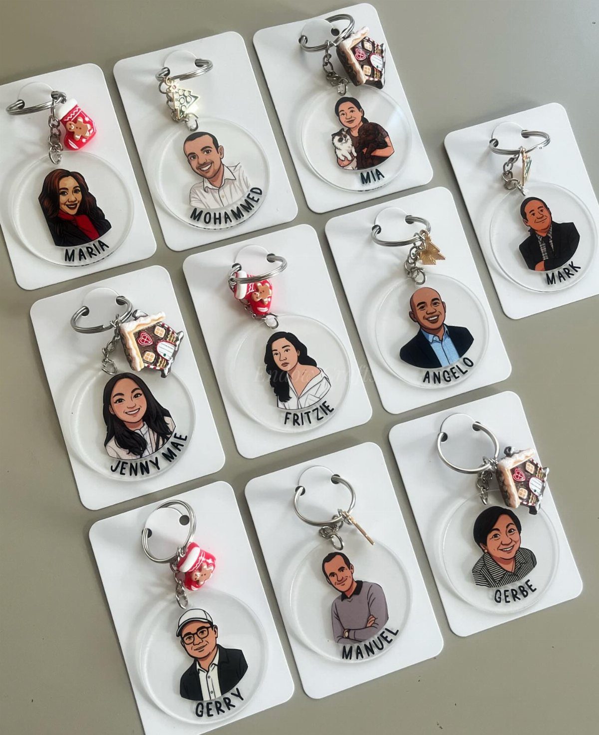 Custom acrylic keychains featuring cartoon portraits and names of different people.