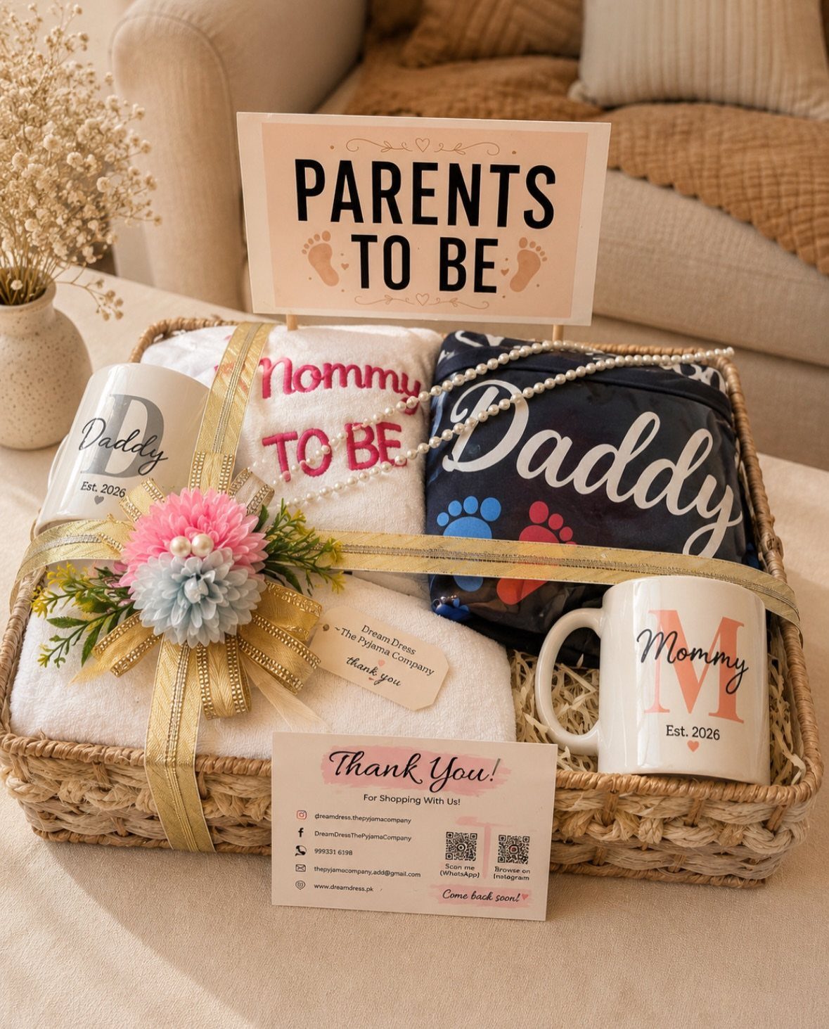 Woven gift basket with Mommy and Daddy mugs, shirts, and Parents to Be sign.