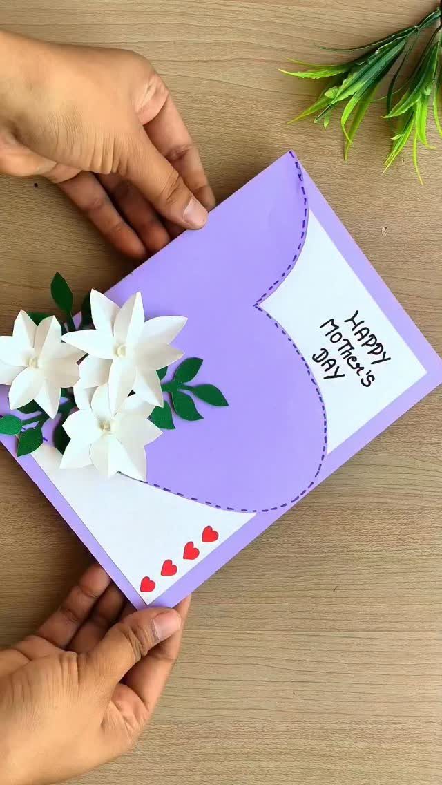 Handmade purple Mother's Day card with white paper flowers and a heart shape.