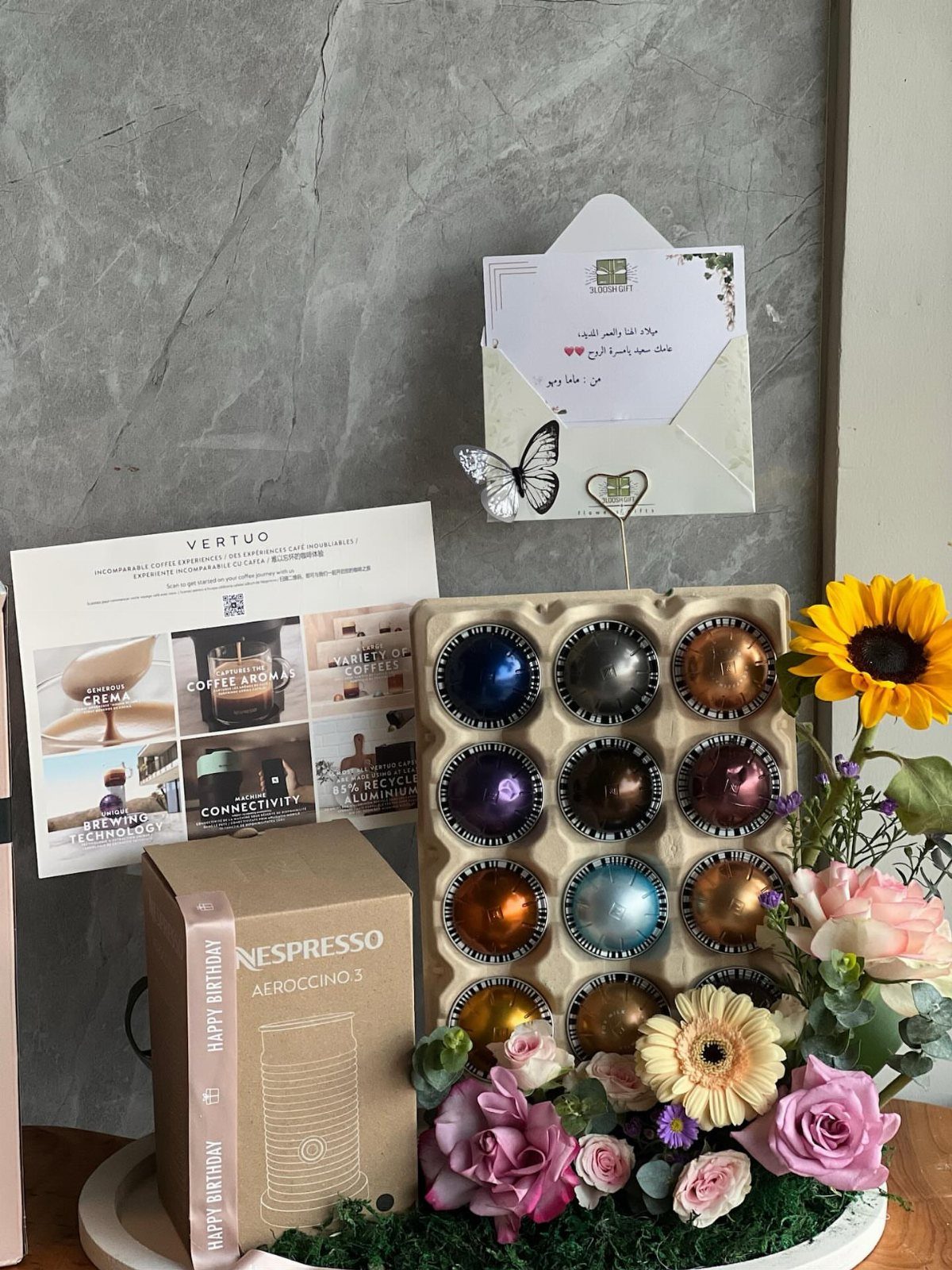 Nespresso Gift Basket Ideas: 5 Ways to Build One 5 Nespresso gift basket with coffee capsules, Aeroccino milk frother, and fresh colorful flowers.