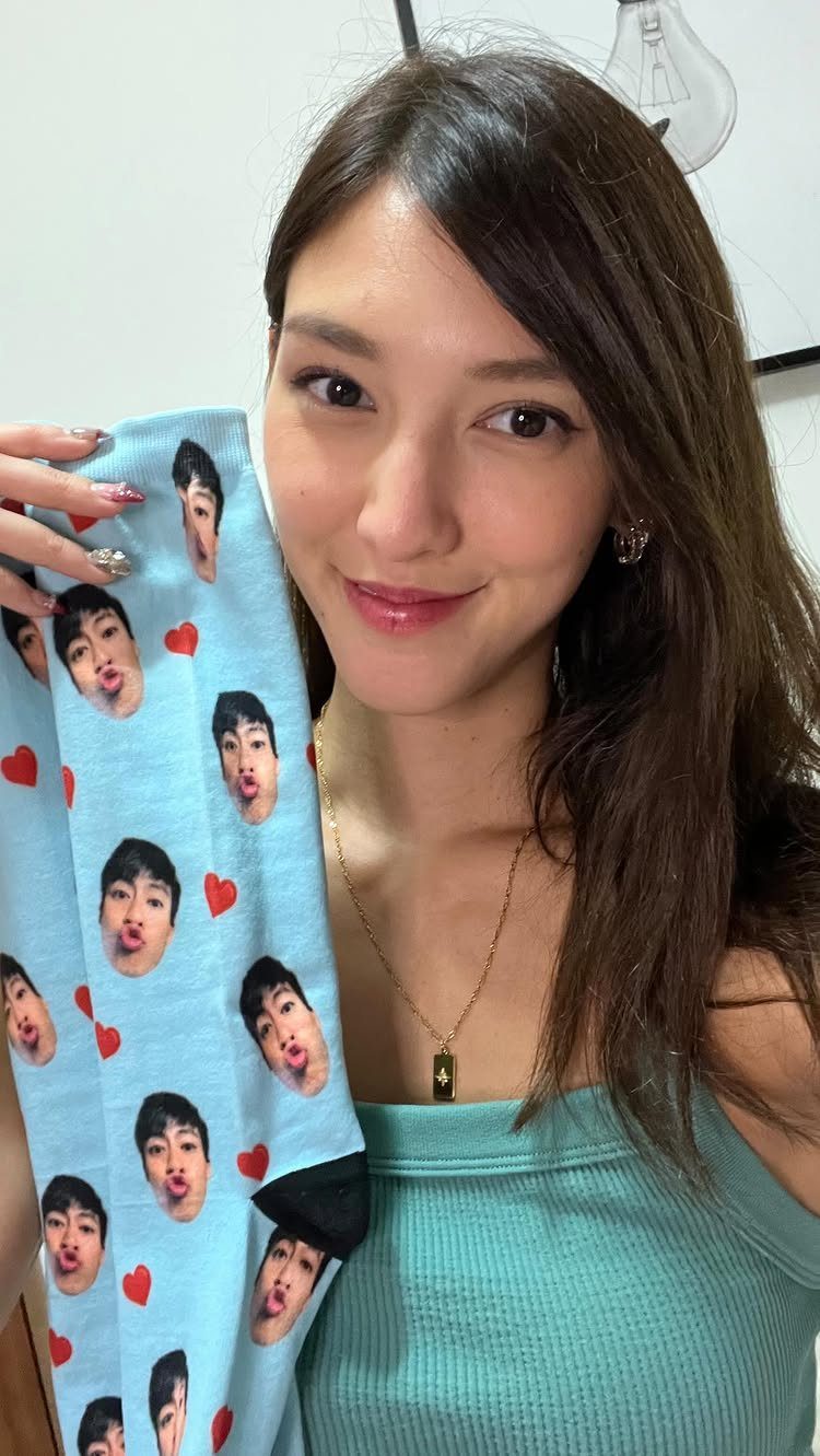 Photo Gifts for Dad From Daughter: 7 Ideas He'll Keep 2 Woman holding a light blue sock printed with a man's face and hearts.