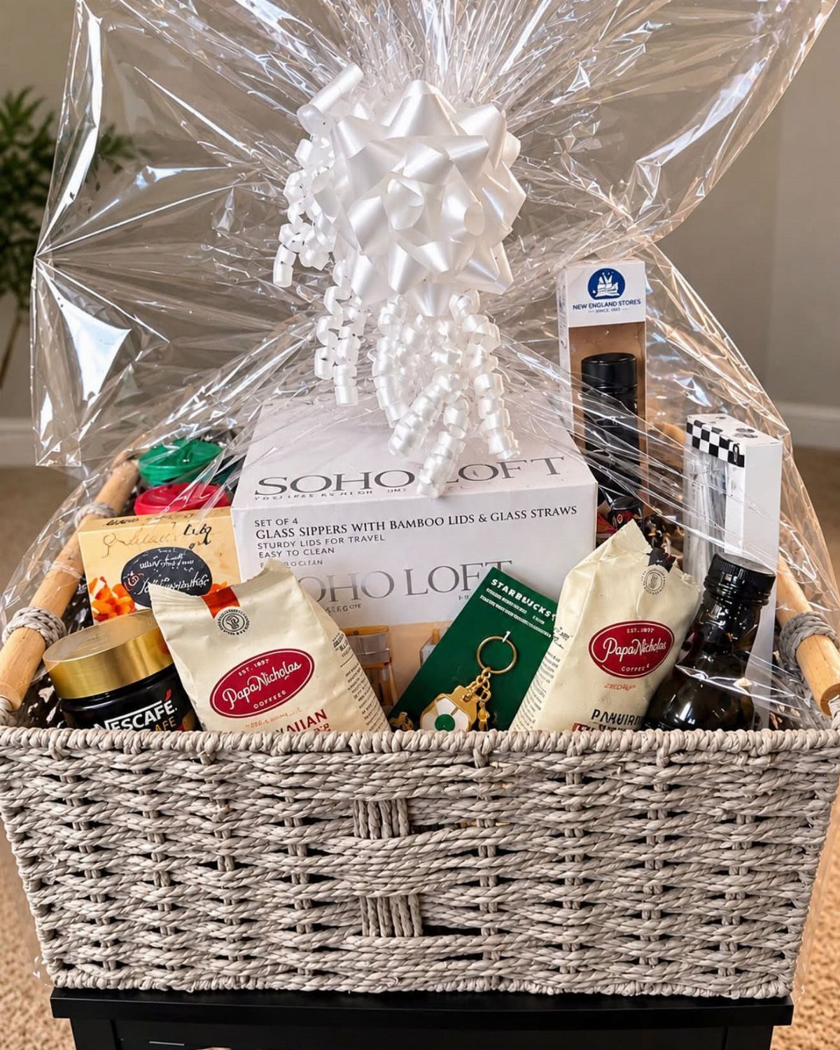 Coffee gift basket with gourmet coffee bags and a Starbucks gift card wrapped in cellophane.