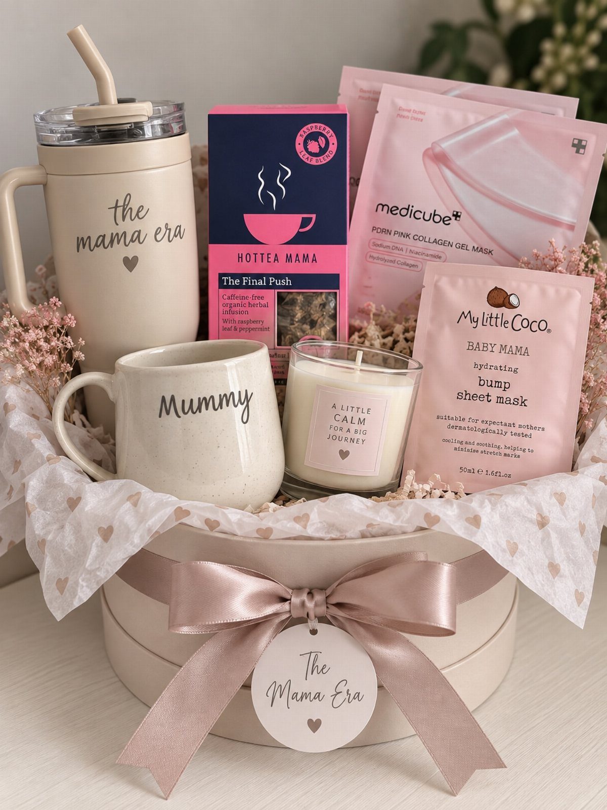 8 Small Gift for Mom Ideas, From Bath Soaks to Baskets 3 Gift basket for a mother with a tumbler, mug, candle, and face masks.