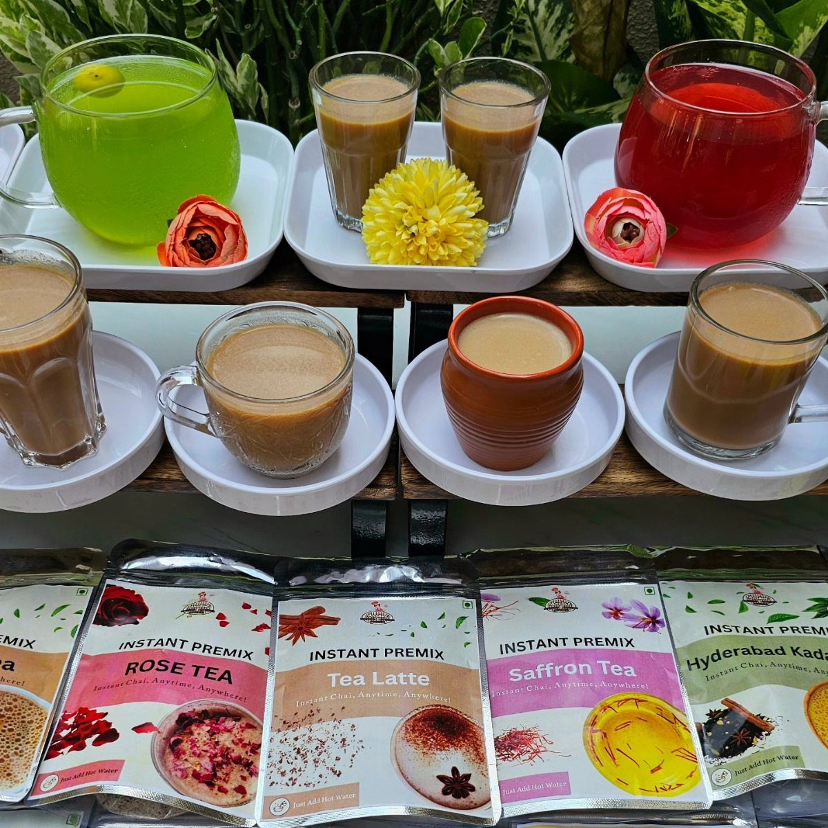 14 Small Unisex Gifts for Friends, Coworkers and Family 13 Assorted colorful tea drinks in glasses and instant tea premix packets on a table.