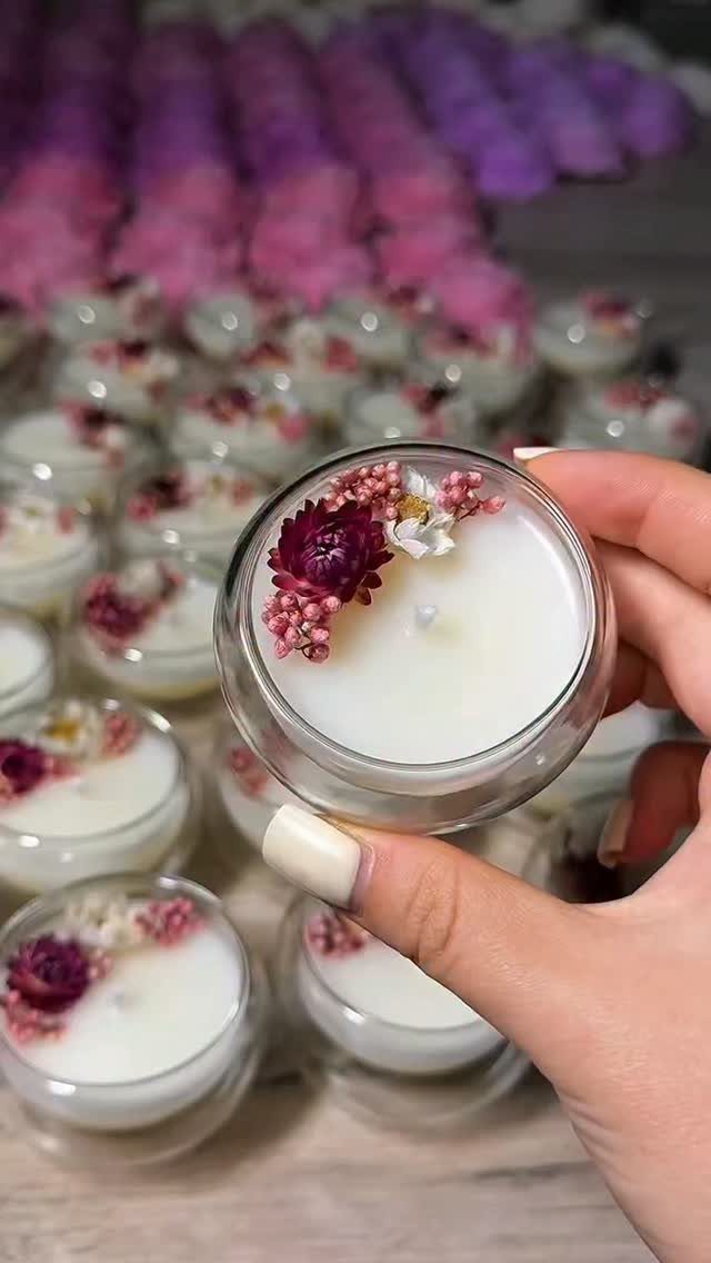 14 Small Unisex Gifts for Friends, Coworkers and Family 14 Small glass jar candle with dried flowers held by a hand