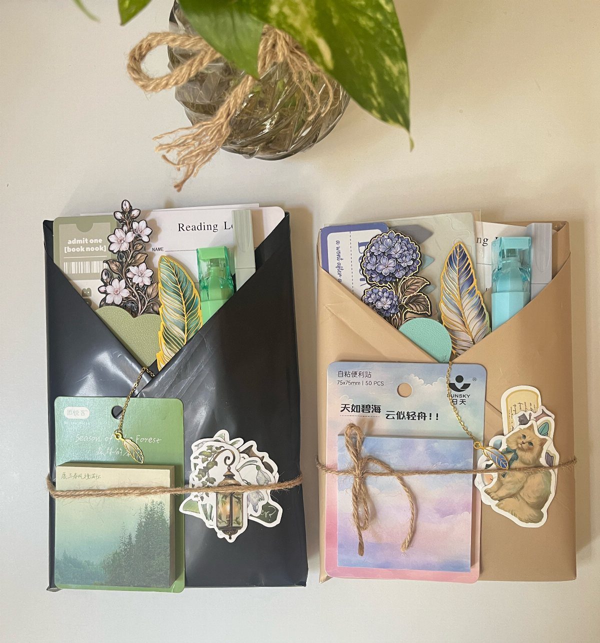 14 Small Unisex Gifts for Friends, Coworkers and Family 8 Two decorated gift envelopes filled with stationery and stickers tied with twine.