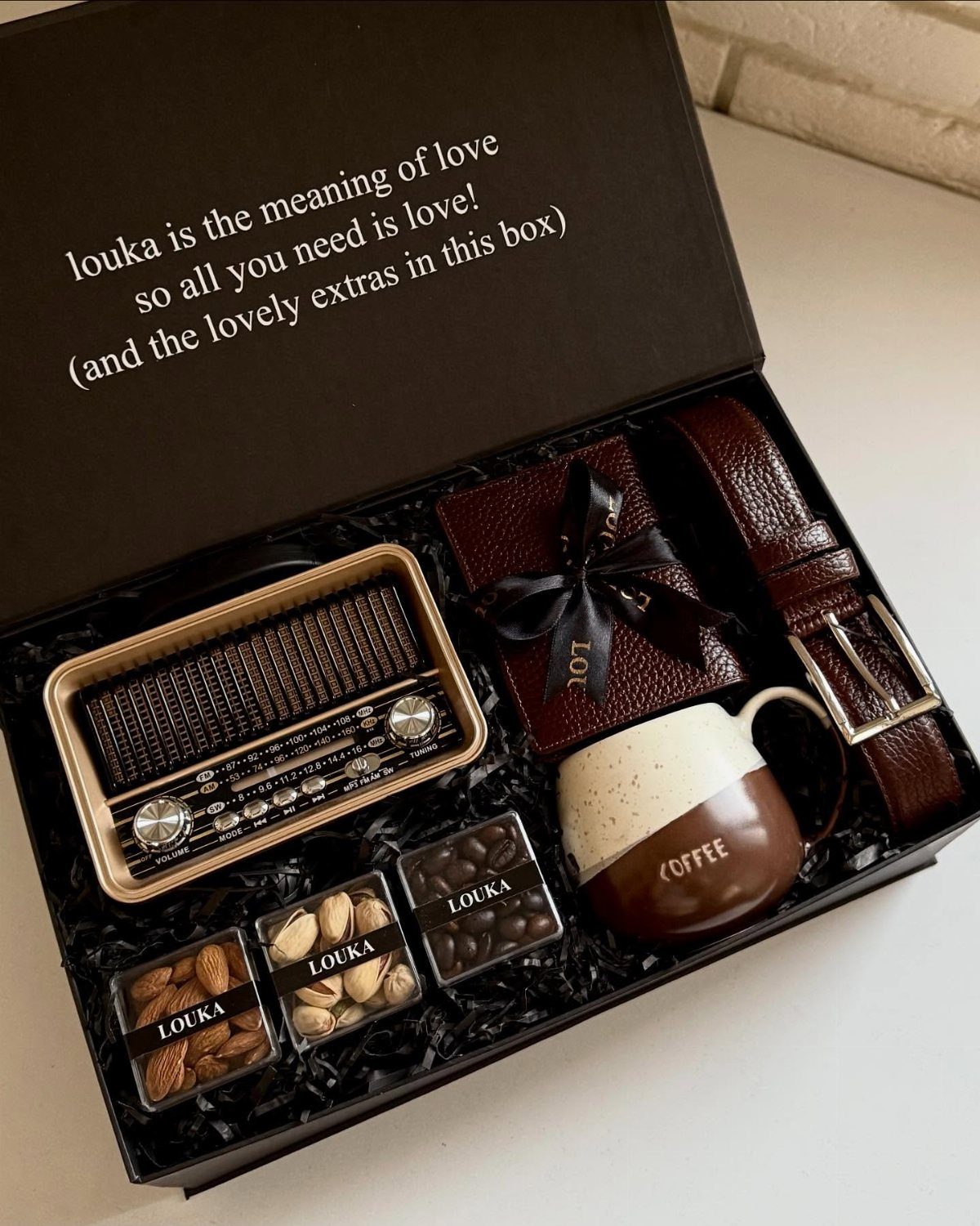 10 Special Gifts for Dad: Personalized Picks He'll Keep 6 Gift box with vintage radio, leather belt, wallet, coffee mug, and snacks.