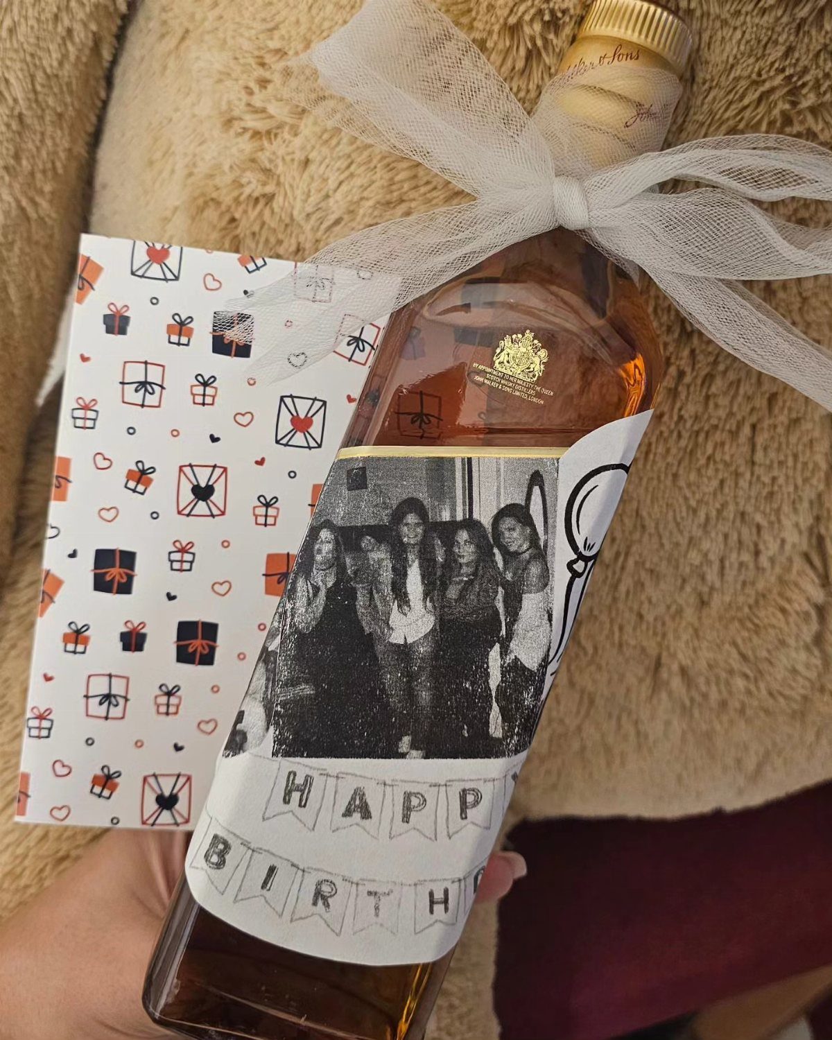 10 Special Gifts for Dad: Personalized Picks He'll Keep 8 Liquor bottle with a personalized birthday label and a white sheer bow.