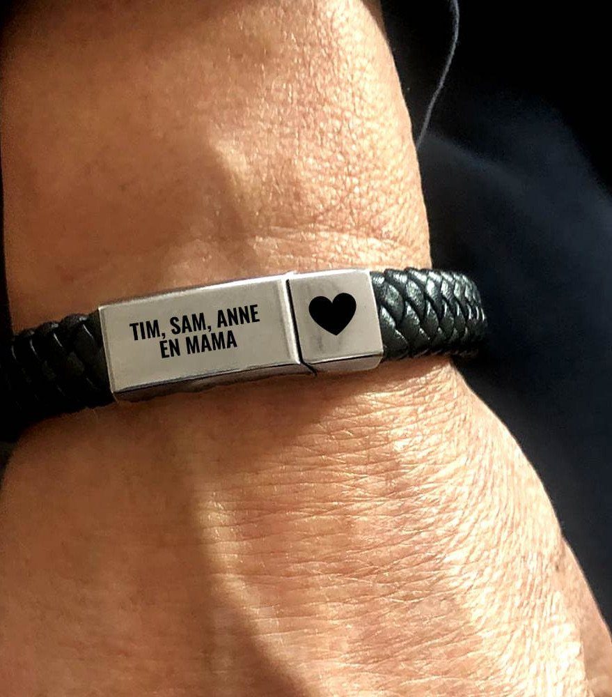 11 Step Father Gifts: From a Pocket Knife to a Photo Plaque 4 Braided leather bracelet with a silver engraved ID plate on a person's wrist.