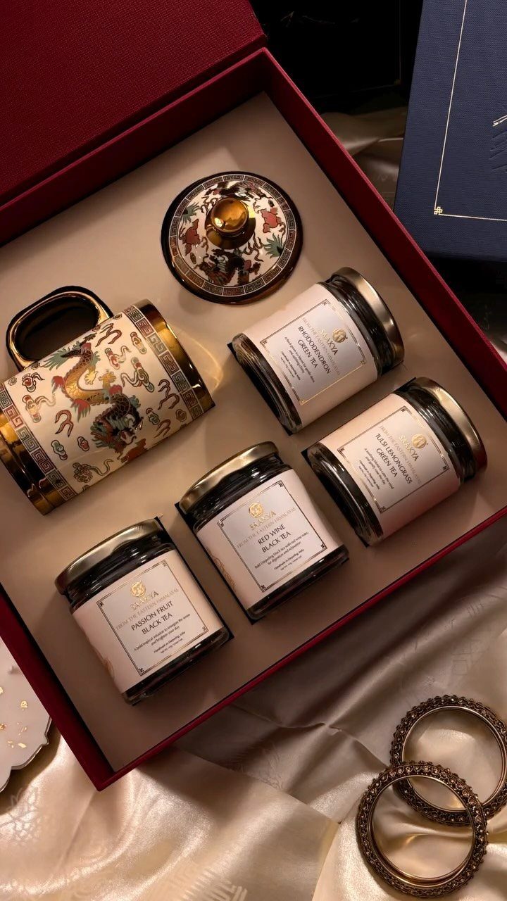 Tea Bag Gift Ideas to Make or Buy: 11 Sweet Picks 5 Tea gift set in a red box with jars, a mug, and accessories.
