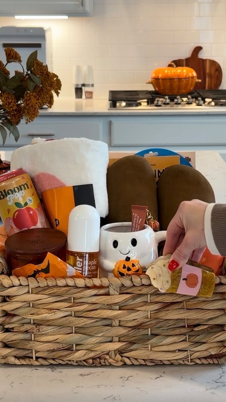 8 Thanksgiving Gift Box Ideas for Hosts and Friends 4 Woven wicker gift basket filled with autumn-themed treats and skincare in a kitchen.