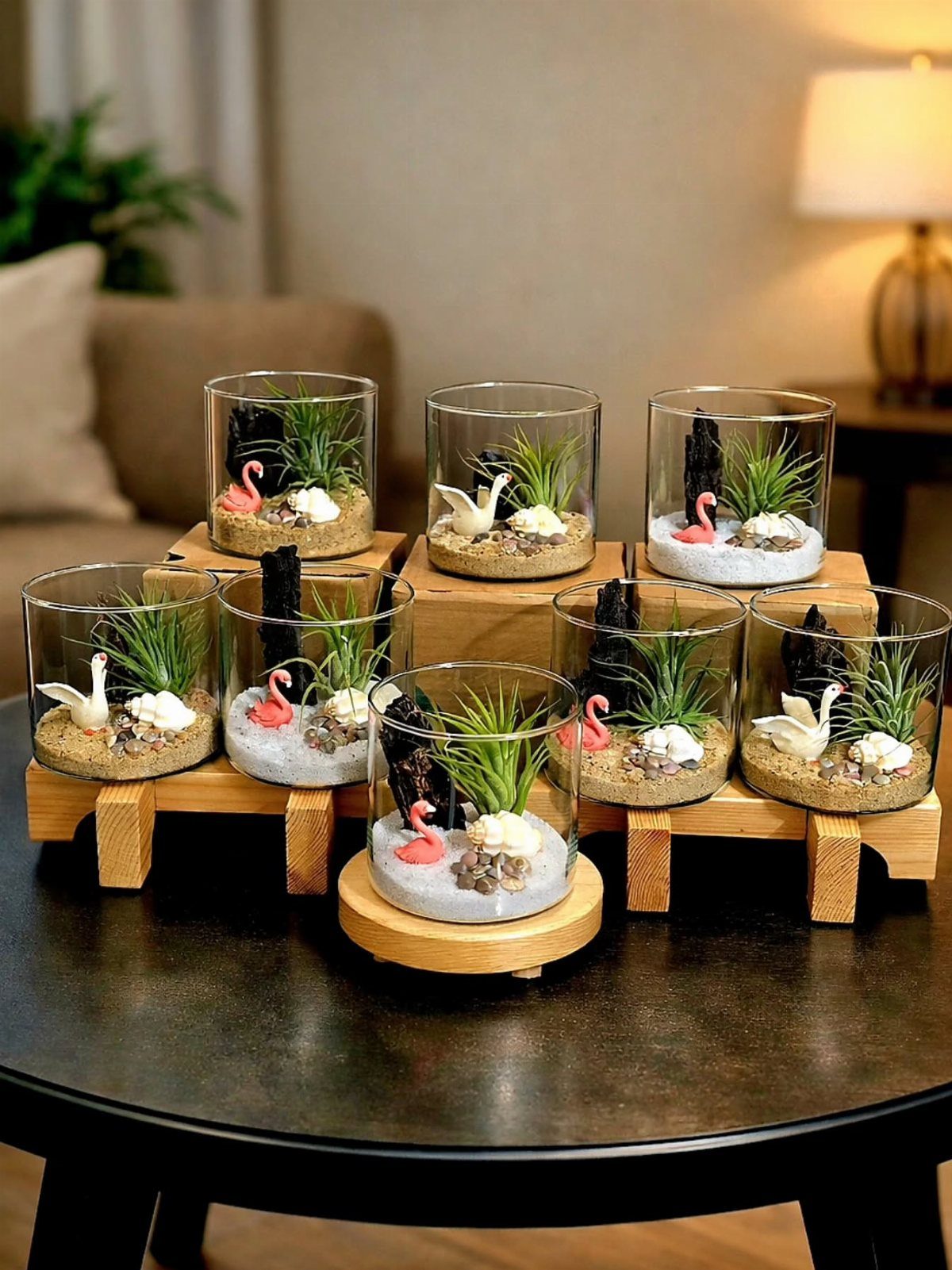 12 Thanksgiving Gifts for Coworkers They'll Actually Use 8 Small glass terrariums with miniature birds and grass on wooden stands on a table