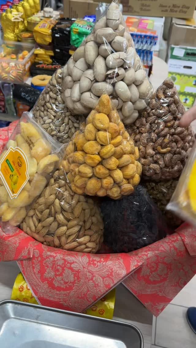 11 Thanksgiving Gifts for Family, From Candles to Cozy Throws 7 Dried fruit and nut gift basket with apricots and almonds in plastic bags