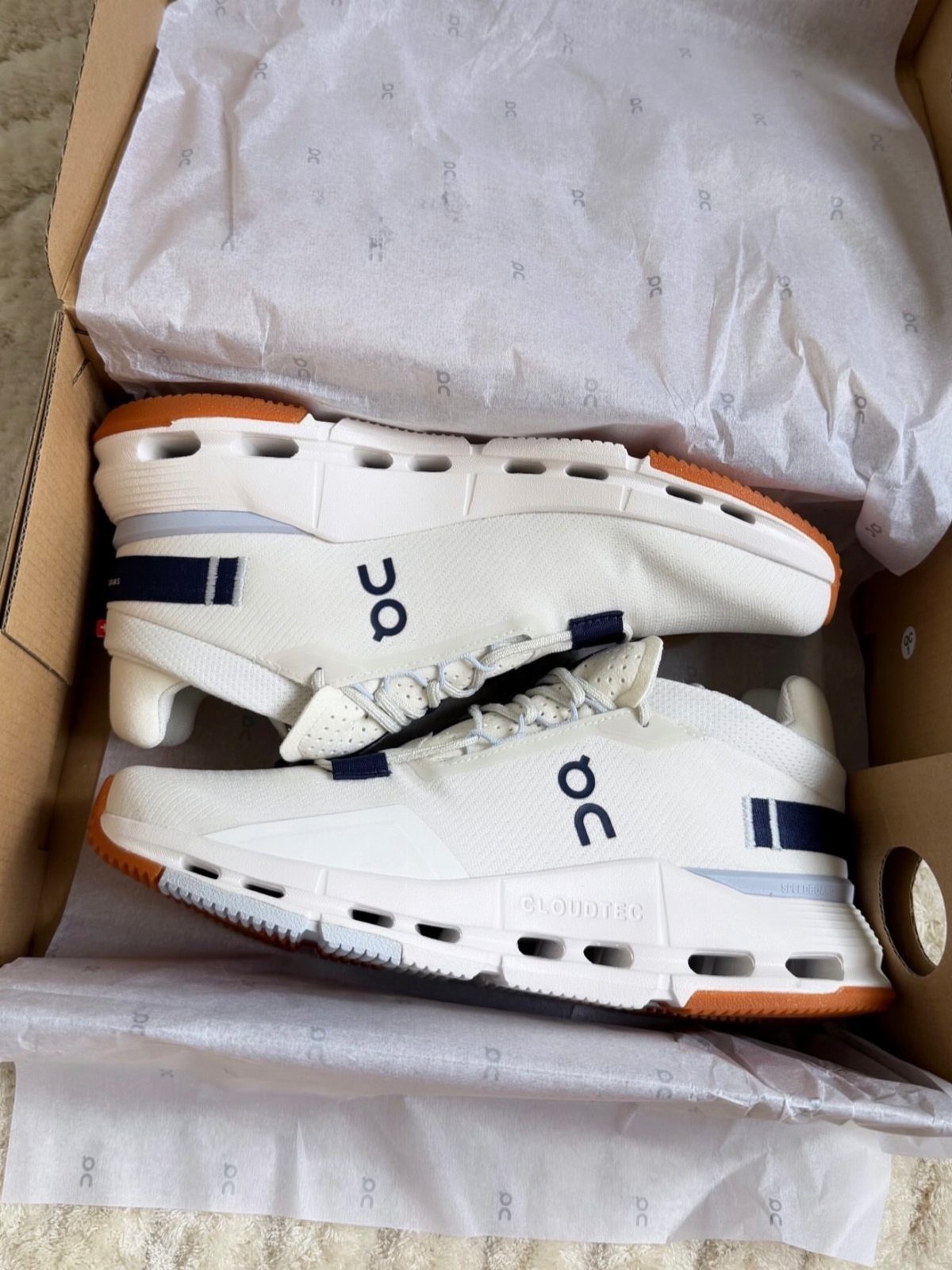 29 Trendy Gift Ideas for Her: The 2026 Gift Guide 1 White On Cloud running shoes with navy accents inside a cardboard shoebox.